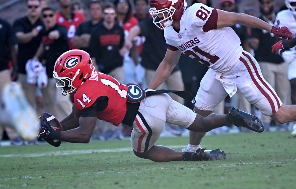 Georgia safety Rasean Dinkins (left) recovers an Oklahoma fumble during the second half Saturday, Sept. 26, 2026, at Sanford Stadium in Athens. Georgia won 41-13. (Hyosub Shin/AJC)