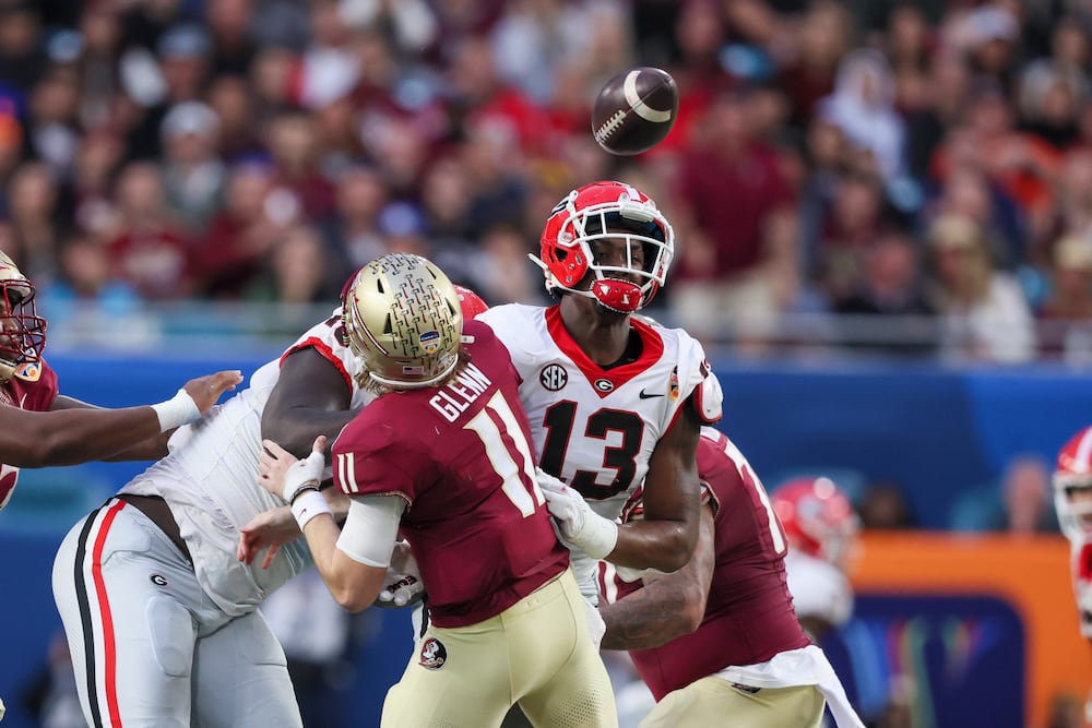 Florida State quarterback Brock Glenn has his pass attempt blocked by Georgia defensive lineman Mykel Williams (right) during the Orange Bowl at the Hard Rock Stadium on Saturday, Dec. 30, 2023, in Miami Gardens, Fla. (Jason Getz/AJC)