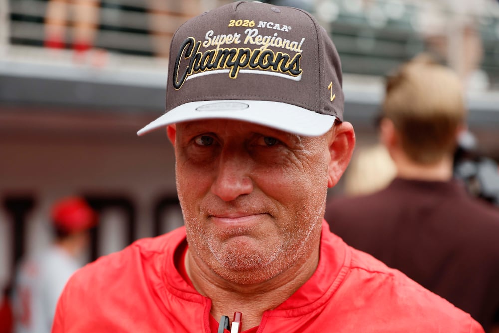 Georgia Bulldogs head coach Wes Johnson reacts while wearing his championship hat as he celebrates with his team after winning the NCAA Super Regional series, defeating the Mississippi State Bulldogs 11-9 at Foley Field on Sunday, June 7, 2026, in Athens. Miguel Martinez/AJC)