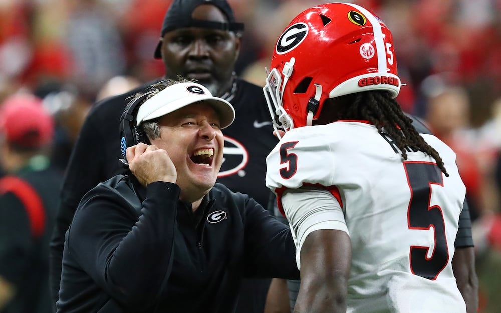 Georgia coach Kirby Smart celebrates with defensive back Kelee Ringo after he intercepted a pass by Alabama quarterback Bryce Young and returned it for a touchdown on Monday, Jan. 10, 2022, in Indianapolis. (Curtis Compton/AJC)