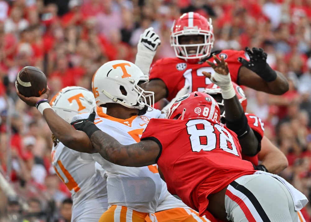 Tennessee quarterback Hendon Hooker (left) is sacked by Georgia defensive lineman Jalen Carter at Sanford Stadium on Saturday, Nov. 5, 2022, in Athens. (Hyosub Shin/AJC)