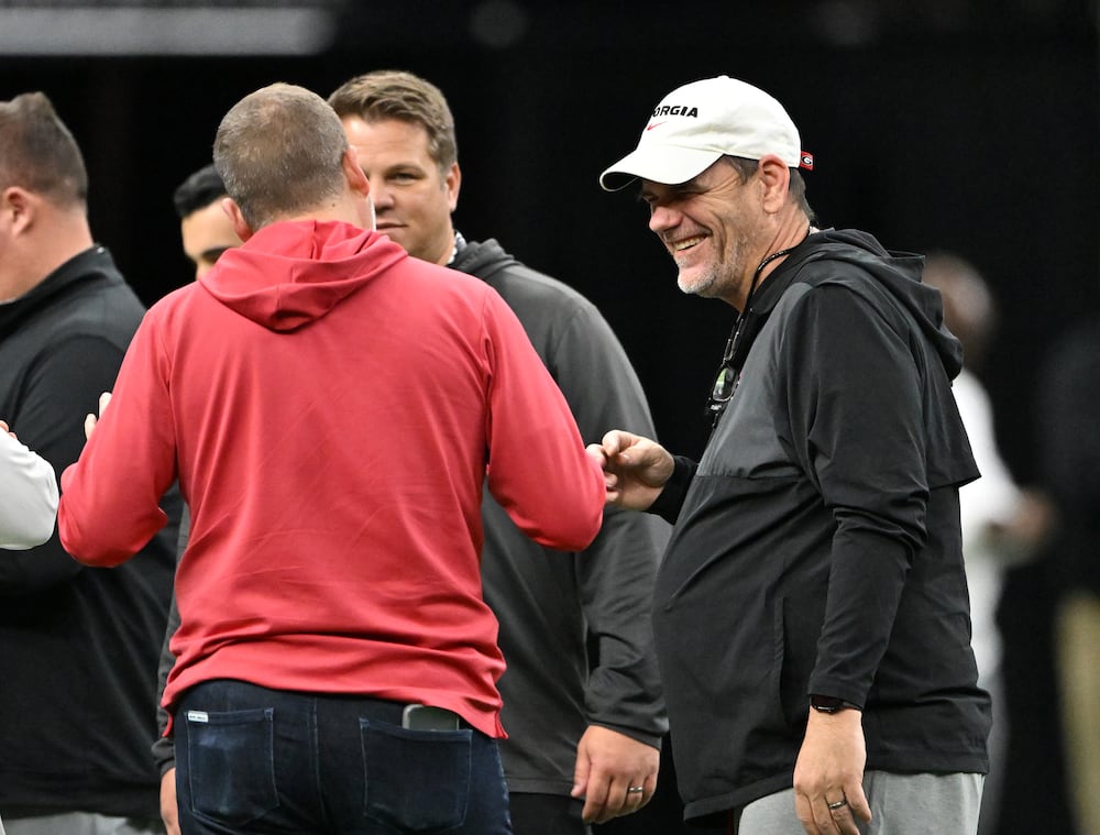 Georgia quarterbacks coach and offensive coordinator Mike Bobo (right) attends the media viewing portion of practice ahead of the Sugar Bowl at the Caesars Superdome on Tuesday, Dec. 30, 2025, in New Orleans. (Hyosub Shin/AJC)