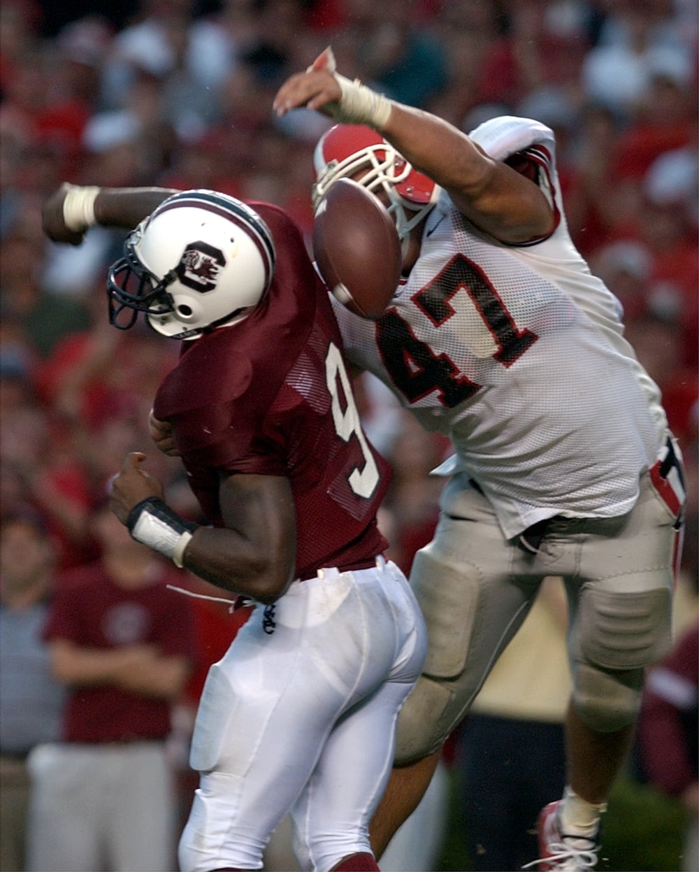 UGAs David Pollack (right) strips the ball from South Carolina quarterback Corey Jenkins in the end zone to score a memorable touchdown. (Brant Sanderlin for the AJC 2002)