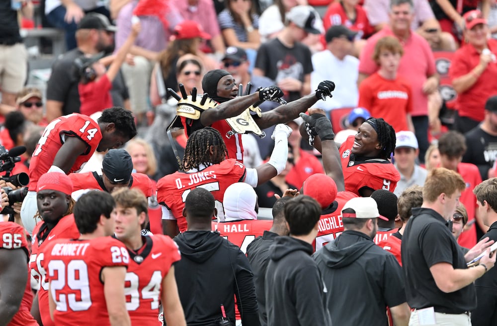 Georgia defensive back Ellis Robinson IV (center) celebrates his interception against Kentucky with his teammates at Sanford Stadium on Saturday, Oct. 4, 2025, in Athens. (Hyosub Shin/AJC)