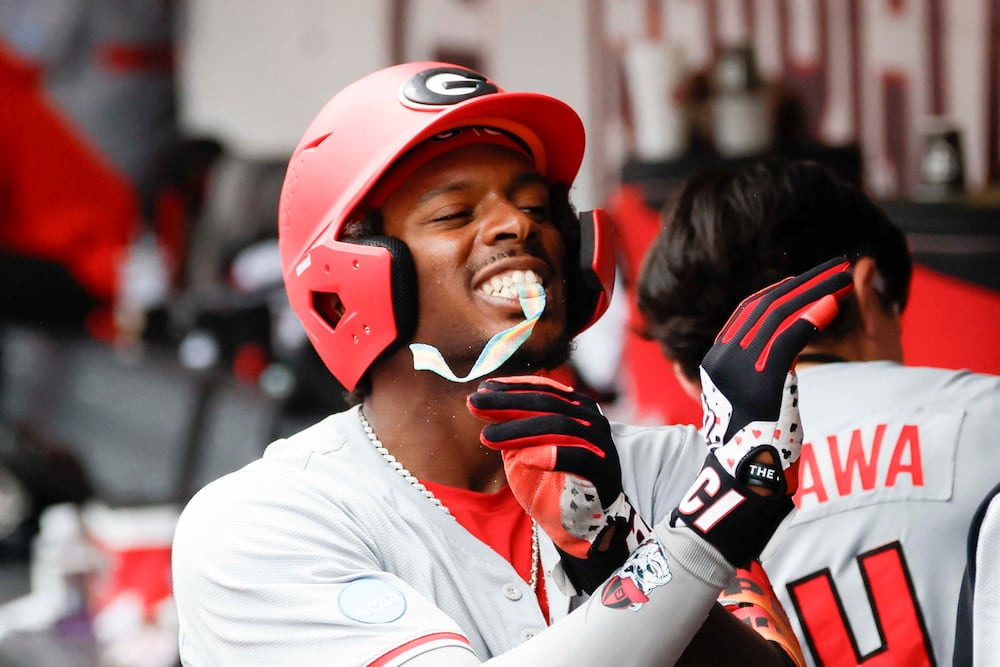 Georgia Bulldogs infielder Tre Phelps (1) receives sour candy after scoring a run during the first inning of game 2 of the NCAA Super Regional at Foley Field on Sunday, June 7, 2026, in Athens. Miguel Martinez/AJC)