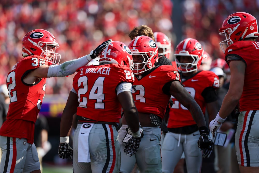 Georgia running back Bo Walker is congratulated by teammates after scoring his second touchdown during their game against Charlotte at Sanford Stadium on Friday, Nov. 22, 2025. (Jason Getz/AJC)