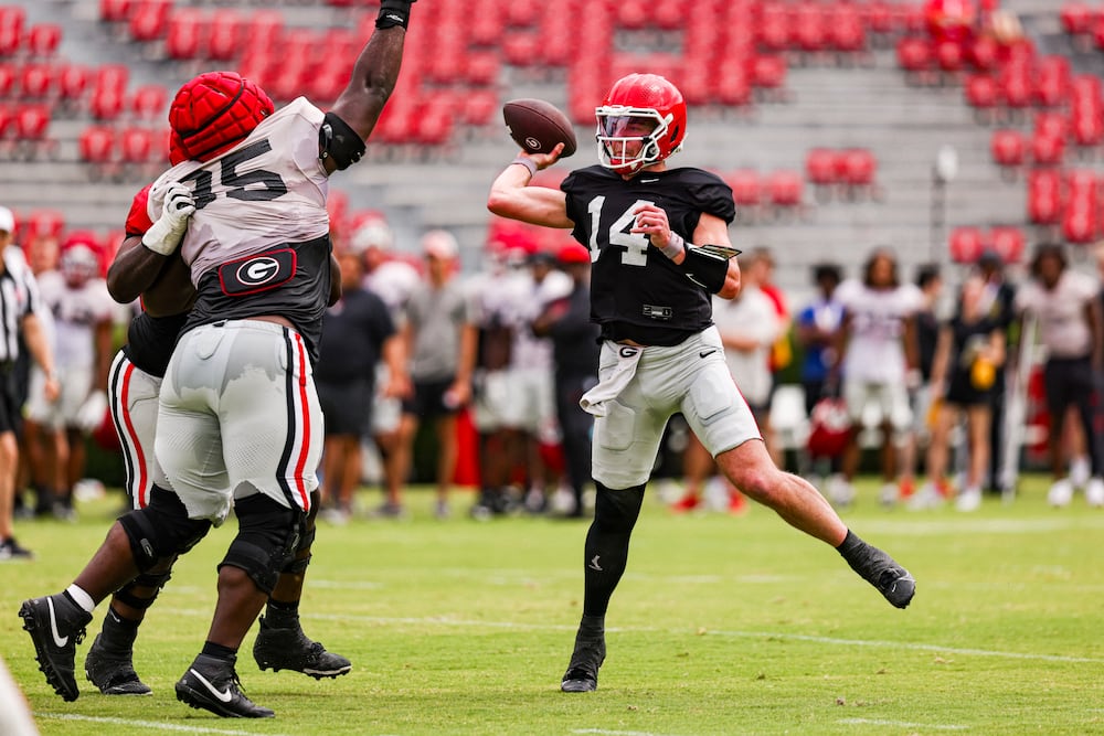 Georgia quarterback Gunner Stockton (right) throws during the Bulldogs' practice session on Dooley Field at Sanford Stadium on Saturday, April 4, 2026, in Athens. (Tony Walsh/UGAAA)