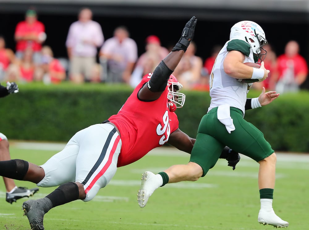 Georgia defensive lineman Jordan Davis shows some speed running down UAB quarterback Tyler Johnston III from behind on a quarterback keeper in 2021. (Curtis Compton/AJC)