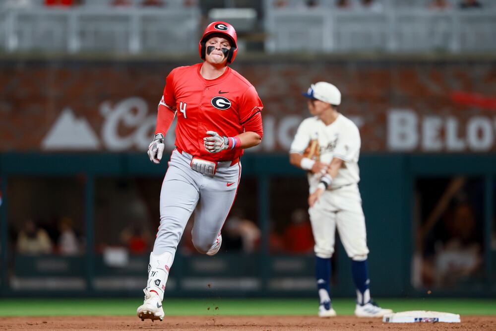 Georgias Michael O'Shaughnessy jogs around the bases after hitting a solo home run during the fifth inning against Georgia Tech in a NCAA baseball game at Truist Park, Tuesday, April 21, 2026, in Atlanta. (Jason Getz/AJC)