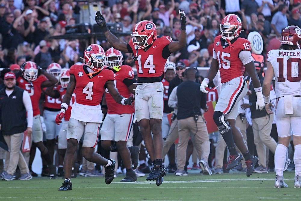 Georgia safety Rasean Dinkins (center) celebrates after recovering an Oklahoma fumble Saturday, Sept. 26, 2026, at Sanford Stadium in Athens. (Hyosub Shin/AJC)