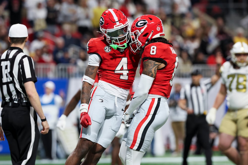 Georgia defensive backs KJ Bolden (left) and Joenel Aguero celebrate after a play against Georgia Tech in November in Atlanta. (Jason Getz/AJC 2025)