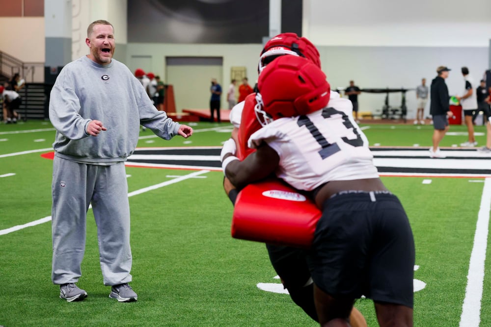 Glenn Schumann, Georgia's defensive coordinator, yells instructions during their first fall football practice on Wednesday, Aug. 5, 2026, in Athens. (Miguel Martinez/AJC)