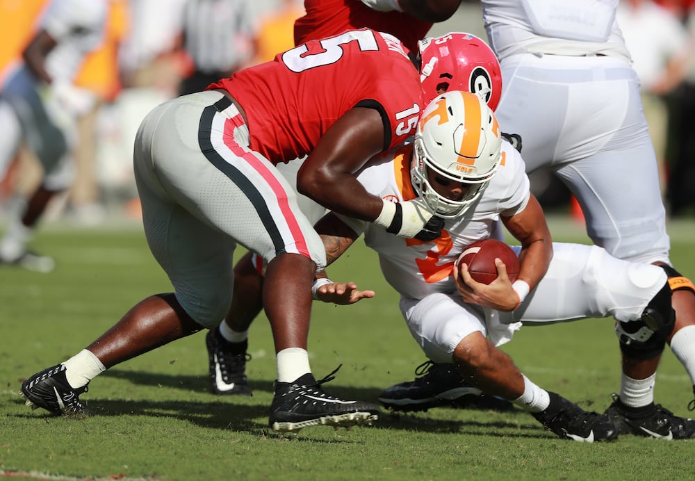 Georgia linebacker DAndre Walker sacks Tennessee quarterback Jarrett Guarantano during the second quarter of a NCAA game on Saturday, Sept 29, 2018, in Athens. (Curtis Compton/AJC)