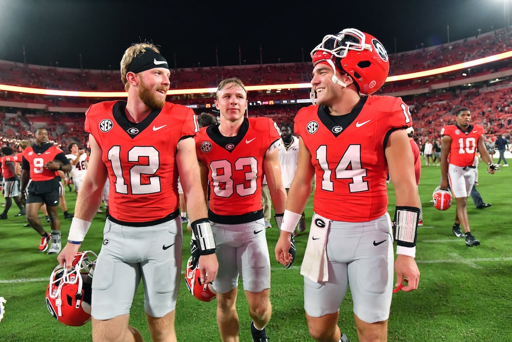 Georgia quarterback Brock Vandagriff (from left), wide receiver Cole Speer and quarterback Gunner Stockton leave the field after the Bulldogs beat UT Martin, 48-7, at Sanford Stadium on Saturday, Sept. 2, 2023, in Athens. (Hyosub Shin/AJC)