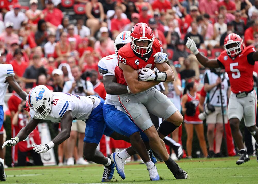 Georgia tight end Jaden Reddell (front) pushes past Tennessee State linebacker Matthew Wilson for a touchdown at Sanford Stadium on Saturday, Sept. 5, 2026, in Athens. (Hyosub Shin/AJC)